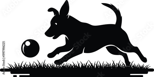 Black silhouette of a dog playing with a ball on grass