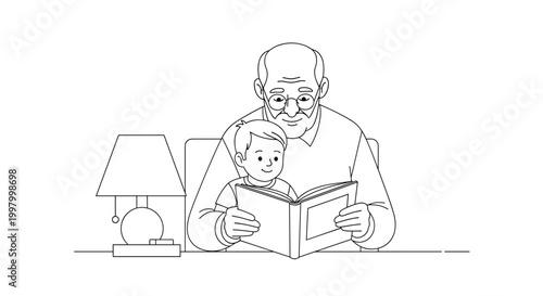 Loving grandfather wearing glasses sits at a desk while reading an interesting and educational storybook to his young grandson.