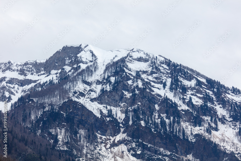 Obraz premium Cold mountain scene, snow, trees, clouds