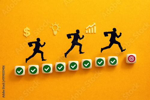 Businessmen silhouettes race across a path of wooden cubes marked with checkmarks toward a target to visualize team performance and strategic planning in a corporate.