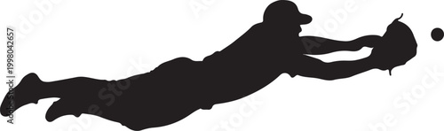 Baseball player diving for a catch in silhouette