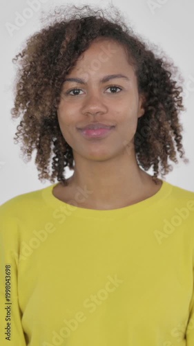 Young African Woman showing Thumbs Up Sign on White Background, Vertical Video