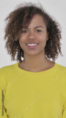 Young African Woman Pointing at the Camera on White Background, Vertical Video