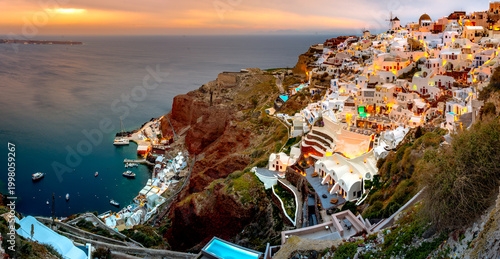 Oia town on Santorini island, Greece. Traditional and famous houses and churches with blue domes over the Caldera, Aegean sea