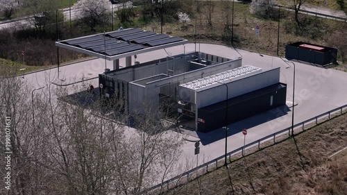 Aerial close-up of hydrogen refueling station with solar panels, clean energy infrastructure and sustainable fuel technology concept 