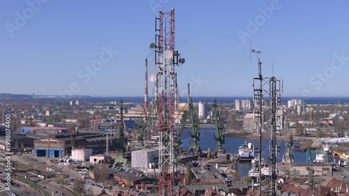 5G telecommunication tower in smart city, digital infrastructure and wireless connectivity concept with urban industrial background, future technology and data network 
