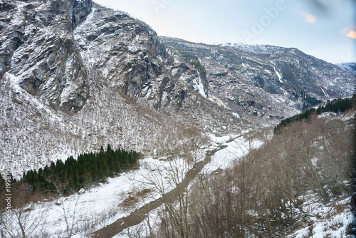 Winter scenery along the Flamsbana railway, Norway in a nutshell route with snowy valley and river