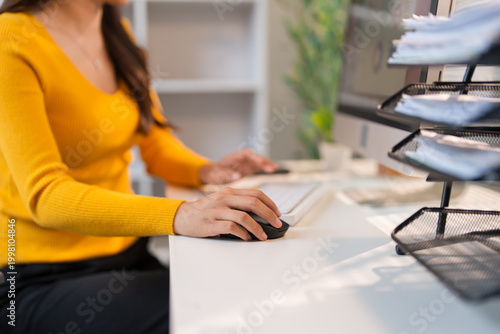 Woman's hand using computer mouse working from home
