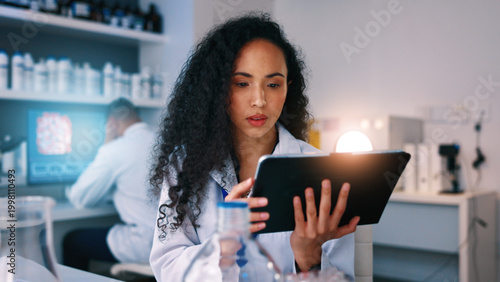 Photos Healthcare, science and woman in lab on tablet for medical review, clinical trial and vaccine development