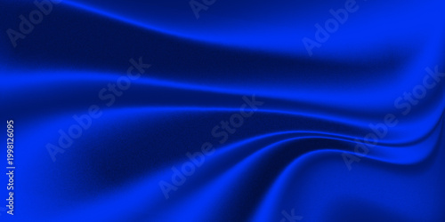 Photos blue design with a wave-like effect, reminiscent of the folds of a luxurious fabric like silk or velvet illuminated by light and a grainy texture