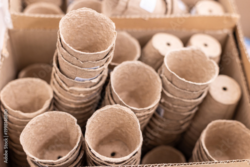 Biodegradable seedling pots paper pulp on wooden table ideal for flowerpot garden balcony ,seeding plant cultivation.