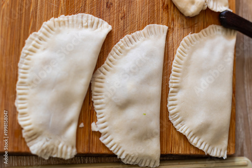 Cooking. Cooking chebureks. Raw meat in dough. A national dish. Cheburek - fried pie with meat and onions. 