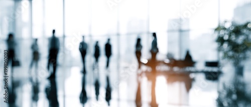 Blurred view of people walking inside a building with reflective floor