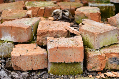 old brick. red brick. a haphazardly thrown pile of old broken bricks. a concept of a ruin, a war or natural disaster, construction, renovation. for background and text. close-up