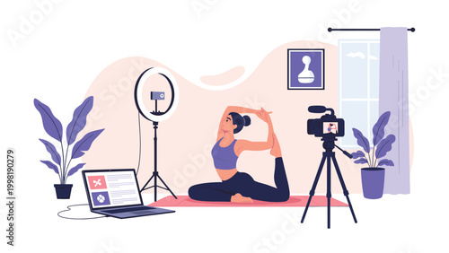 Young woman performs an advanced yoga pose on a mat in a studio equipped with a laptop, professional camera, and ring light for filming.