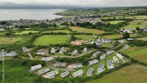 Aerial View of Caravan Park With Coastal Town and Sea in Distance on Anglesey Wales