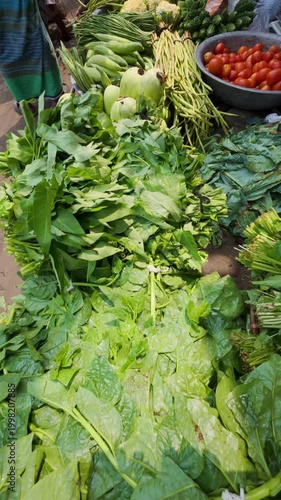 Fresh Organic Green Leafy Vegetables and Assorted Produce Displayed for Sale at a Traditional Outdoor Street Market