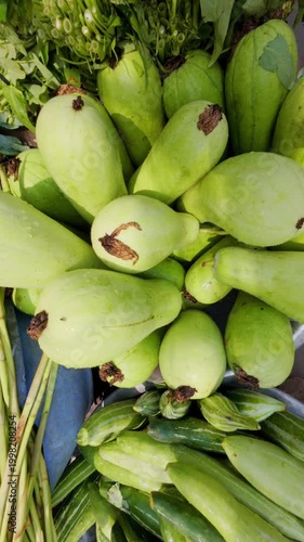 Freshly Harvested Organic Bottle Gourds and Green Vegetables Displayed for Sale at a Local Farmers Market