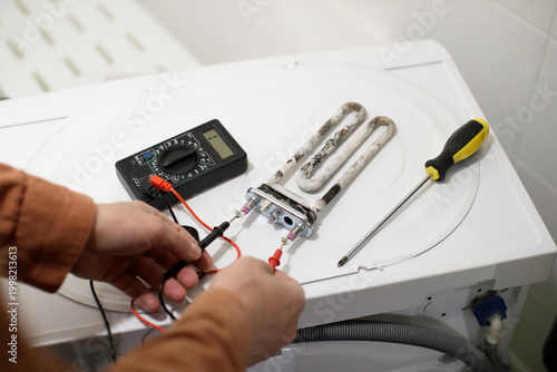 Εκτύπωση καμβά Person checking washing machine heating element for scale