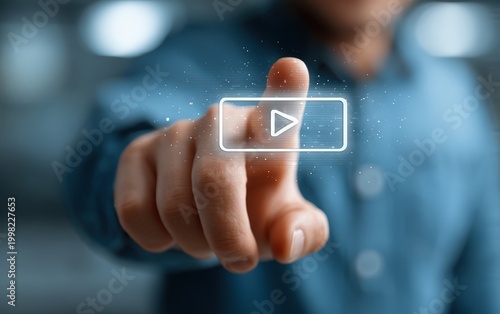 Close up of a Human Finger Touching A Glowing Play Button Icon Over A Blurred Blue Background
