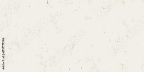 Cream colored textured background with scattered fibers