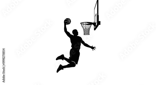 Foto Man dunking basketball in hoop silhouette.