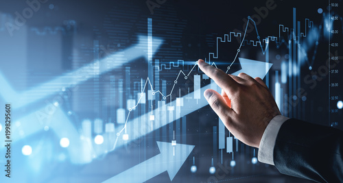 Canvastavla Business hand interacting with rising financial graphs and glowing market indicators showing growth trend on futuristic blue digital background