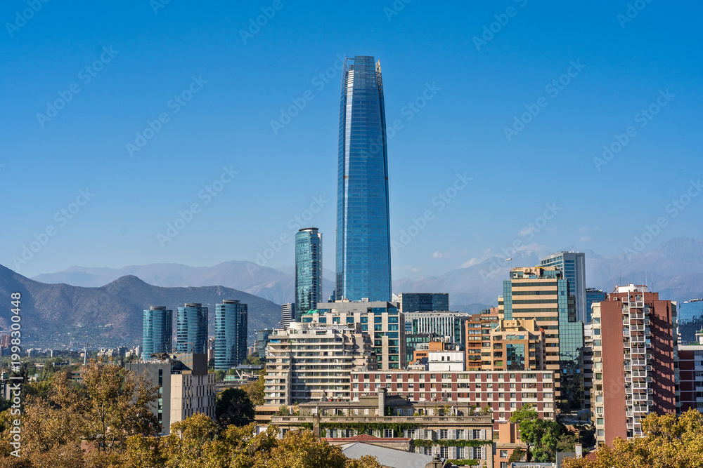 Obraz premium Santiago Chile skyline with Gran Torre Santiago and Andes Mountains under clear blue sky