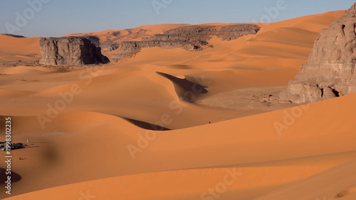 A trip to Sahara desert in Algeria. Beautiful 
african travel photo. Sandy landscapes, mountains, rocks,
dunes, and nature. Summer vacation in arab country.