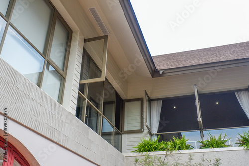 Modern house exterior with casement window and white wall rendering,Large estate minimal home building Window Frame,Cozy home in nature.