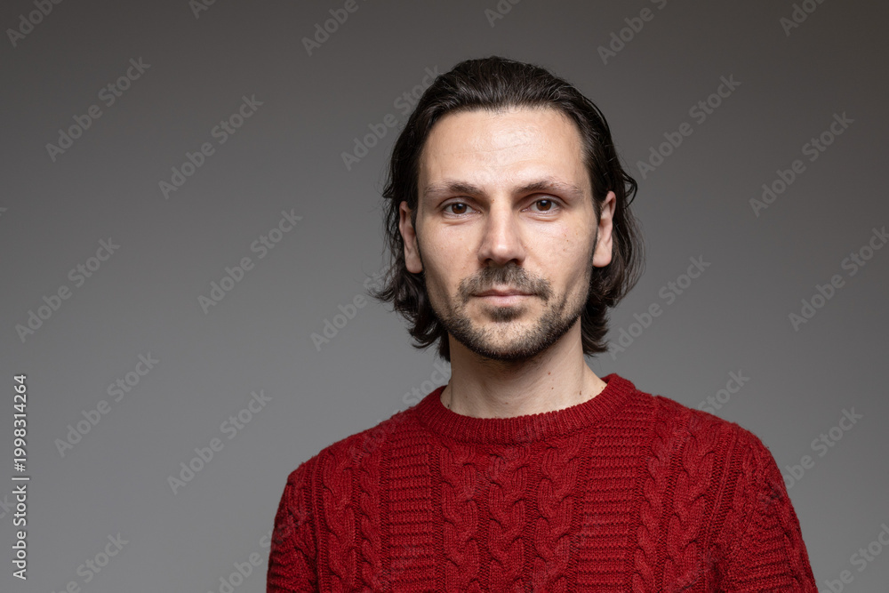 Fototapeta premium Friendly confident man with beard in red sweater professional portrait