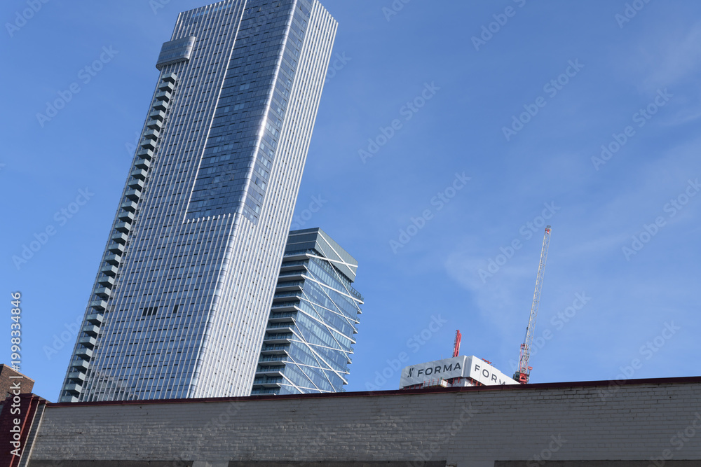Fototapeta premium exterior of 19 Duncan, designed by Hariri Pontarini Architects, mixed-use integration of the heritage Southam Press Building and a modern 58-storey tower, housing Thomson Reuters offices