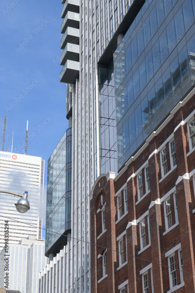Fototapeta premium exterior of 19 Duncan, designed by Hariri Pontarini Architects, mixed-use integration of the heritage Southam Press Building and a modern 58-storey tower, housing Thomson Reuters offices