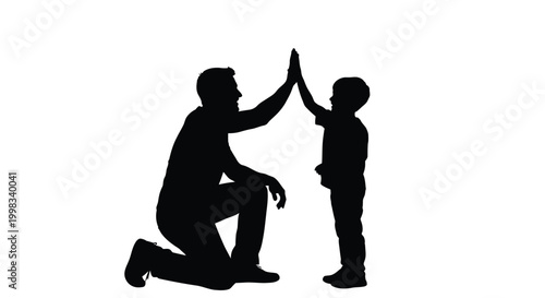 Father and son silhouettes sharing a joyful high-five, symbolizing teamwork, success, and a strong family bond.