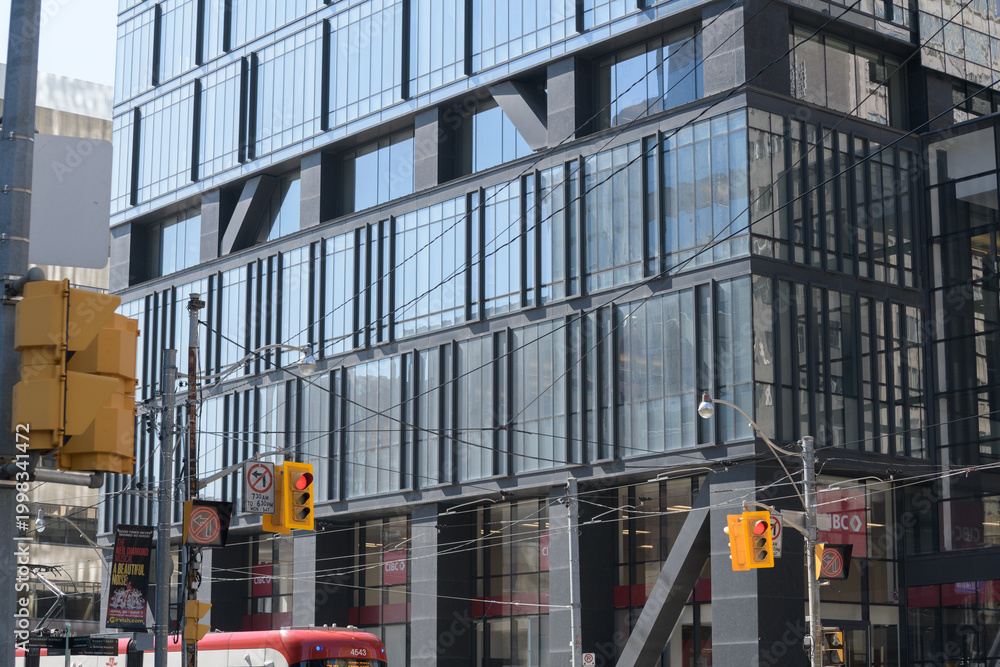 Naklejka premium exterior building facade and sign of CIBC bank branch at 460 University Av (at Dundas St W), Toronto