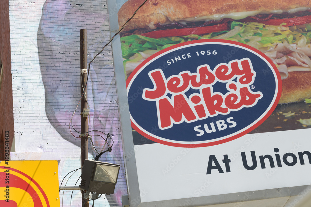 Obraz premium roadside billboard advertisement for Jersey Mike's at Union Station at parking lot near Revery Toronto Downtown, Adelaide St W, Toronto