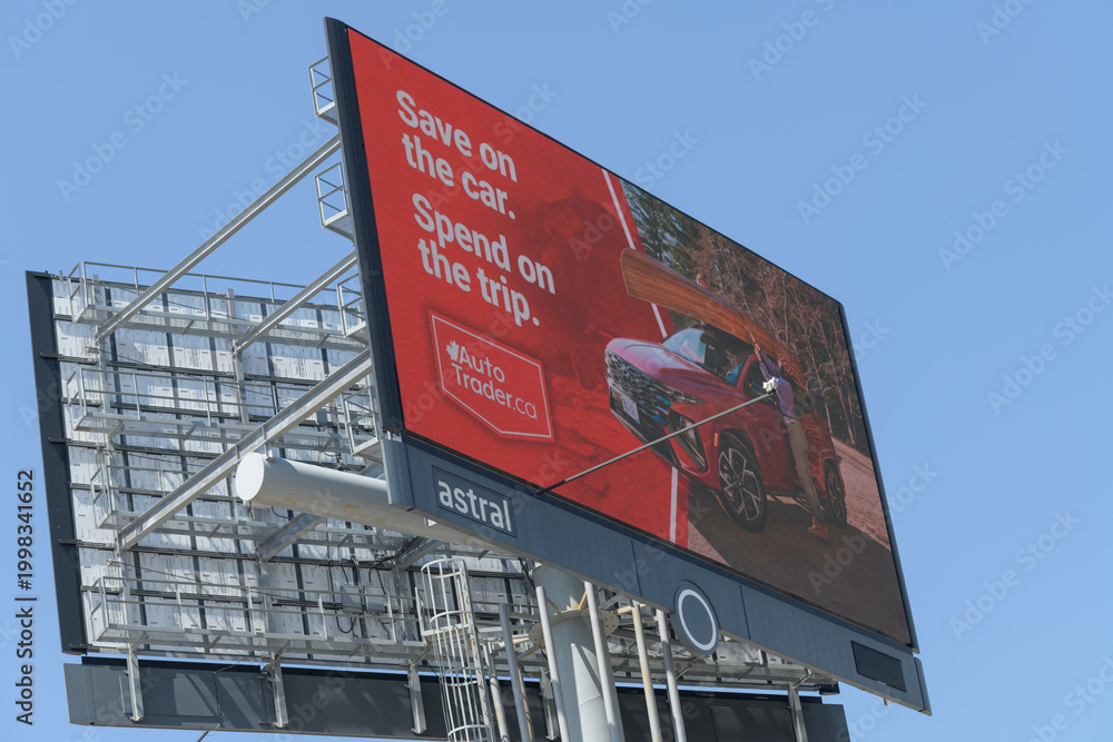 Fototapeta premium roadside pylon led sign featuring advertising for Auto Traders, Toronto