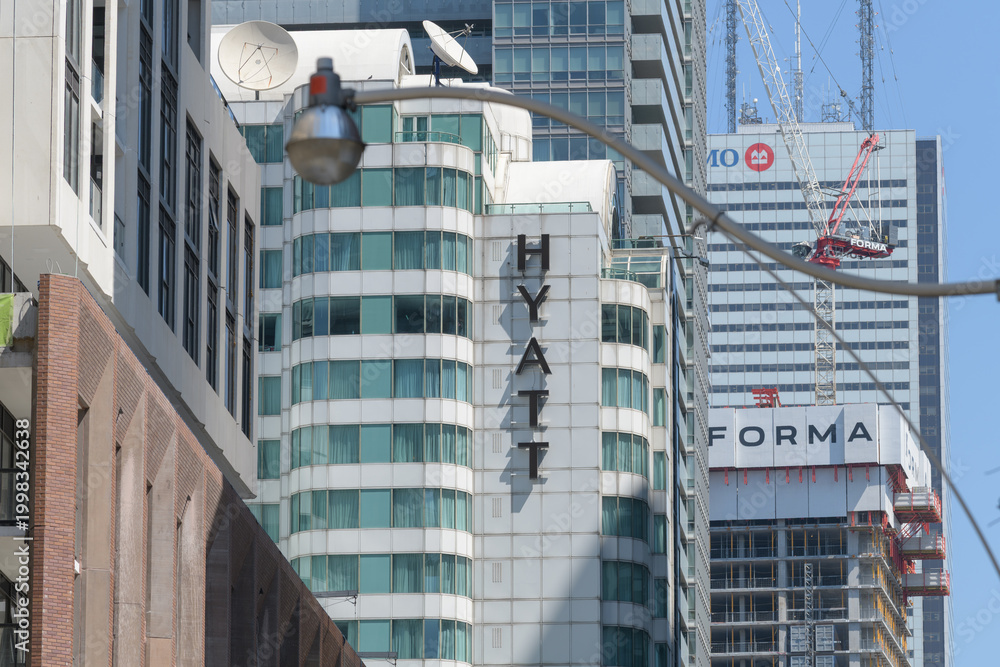 Fototapeta premium looking west on King St W to sign outside Hyatt Regency (a hotel located at 370 King W) and FORMA condos, and BMO at First Canadian Place, Toronto