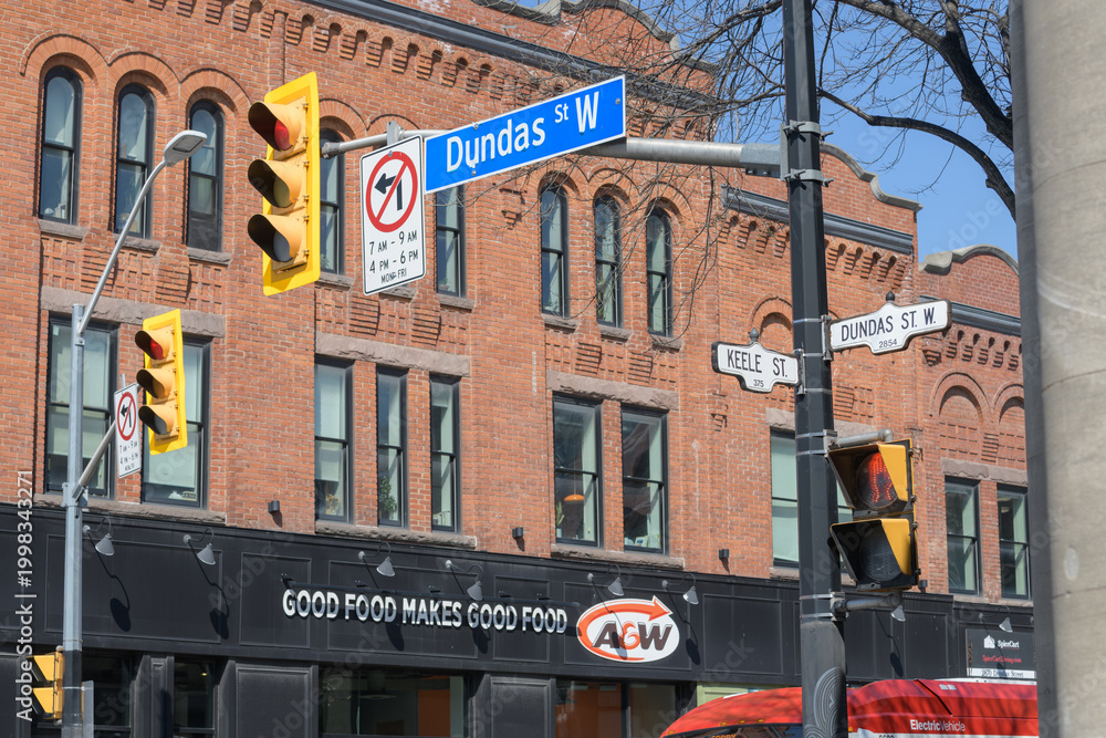 Fototapeta premium exterior building and sign of A&W Canada, a hamburger restaurant chain, located here at 2858 Dundas St W (northwest corner) in historic Campbell Block, The Junction, Toronto