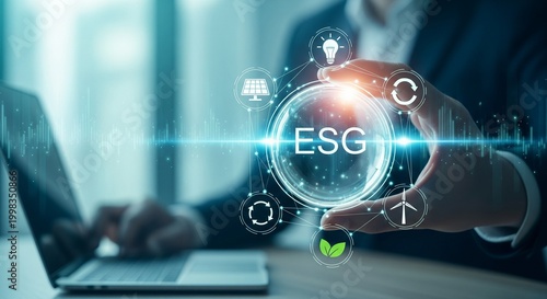 Businessman holding ESG concept circle with icons, laptop and office background