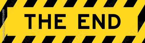 Obraz na płótnie Yellow and black color with line striped label banner with word the end