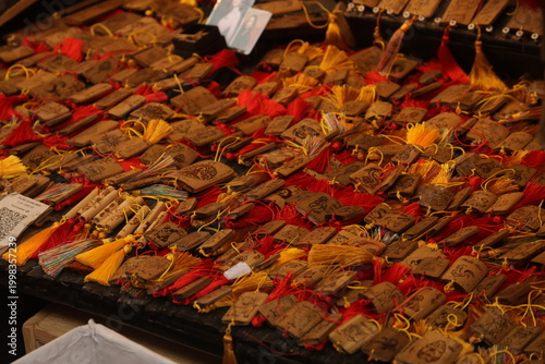 Bild auf Leinwand Display of traditional red lucky amulets and trinkets for sale at a Lunar New Year market in Vietnam