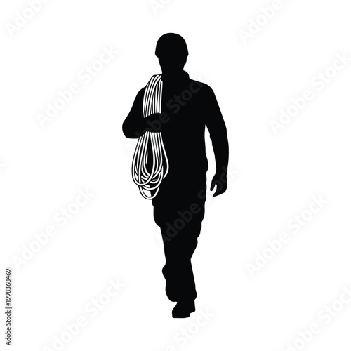 Silhouette of a climber carrying a long rope over the shoulder