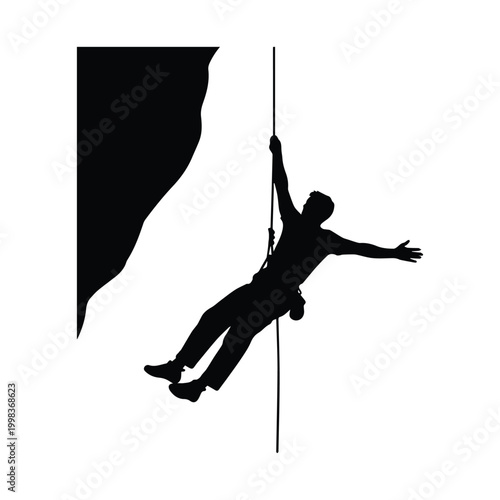 Silhouette of rock climber descending with rope on a cliff face
