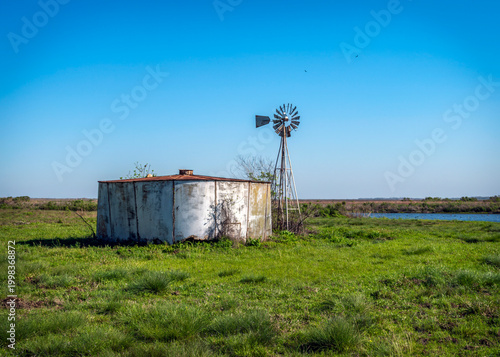 An old windmill along a dirt road in the Brazoria National Wildlife Refuge