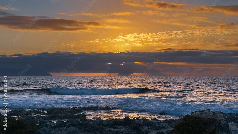 Obraz premium Golden hour light over rocky ocean coast in tropical island Tenerife Spain