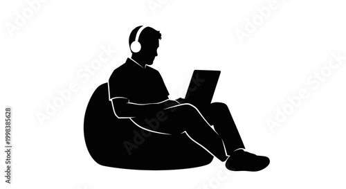 Man sitting with laptop and headphones