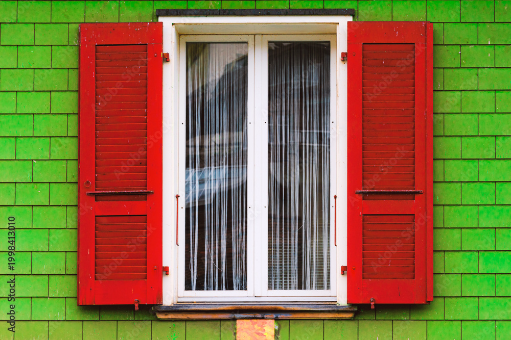 Obraz premium window with red shutters