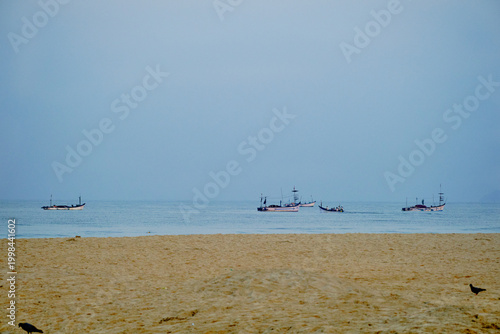 Fishing boats in the sea off Colva beach in Goa, India