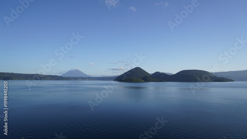Morning view of Lake Toya with volcanic islands and Mt. Yotei, Hokkaido, Japan